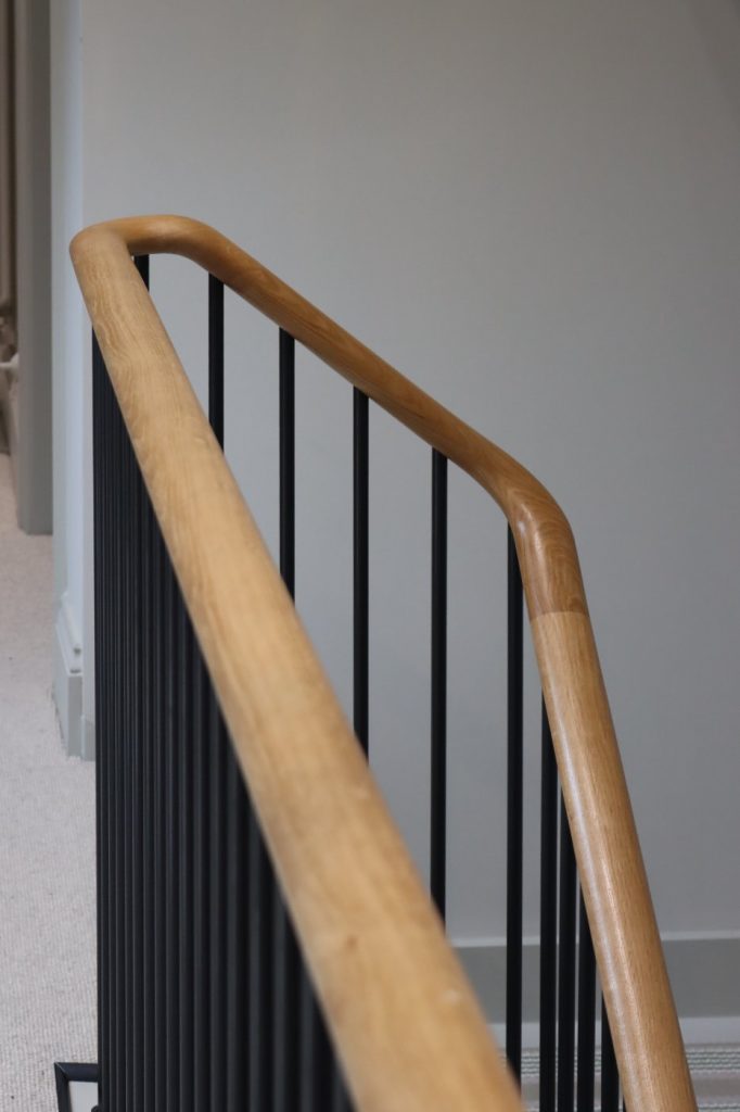 Understanding Your Wooden Handrail Clear lacquered handrail ramping into the wall string