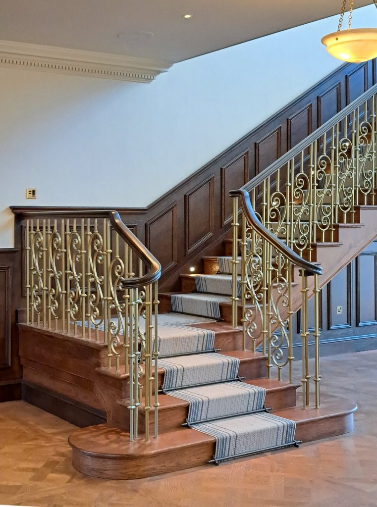 Understanding Your Wooden Handrail Dark-stained handrail from newel to first flight