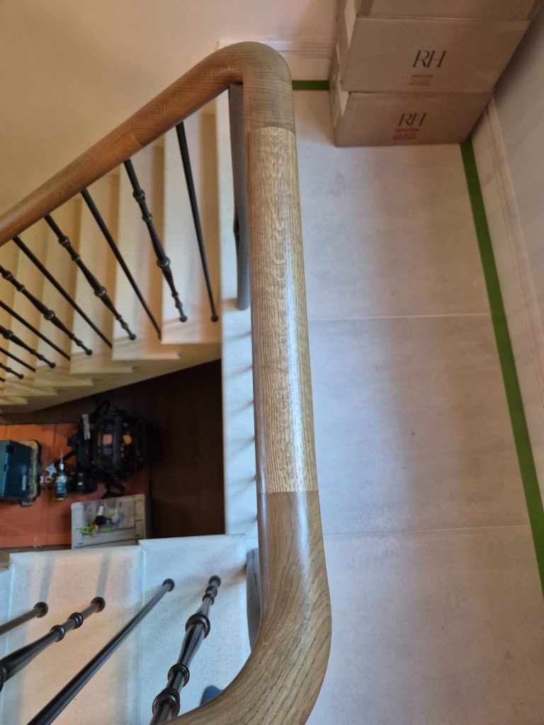 Understanding Your Wooden Handrail Light-stained handrail section joint at a sweep